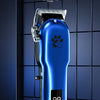 A blue electric pet hair shear grooming kit is displayed against a dark tiled background.