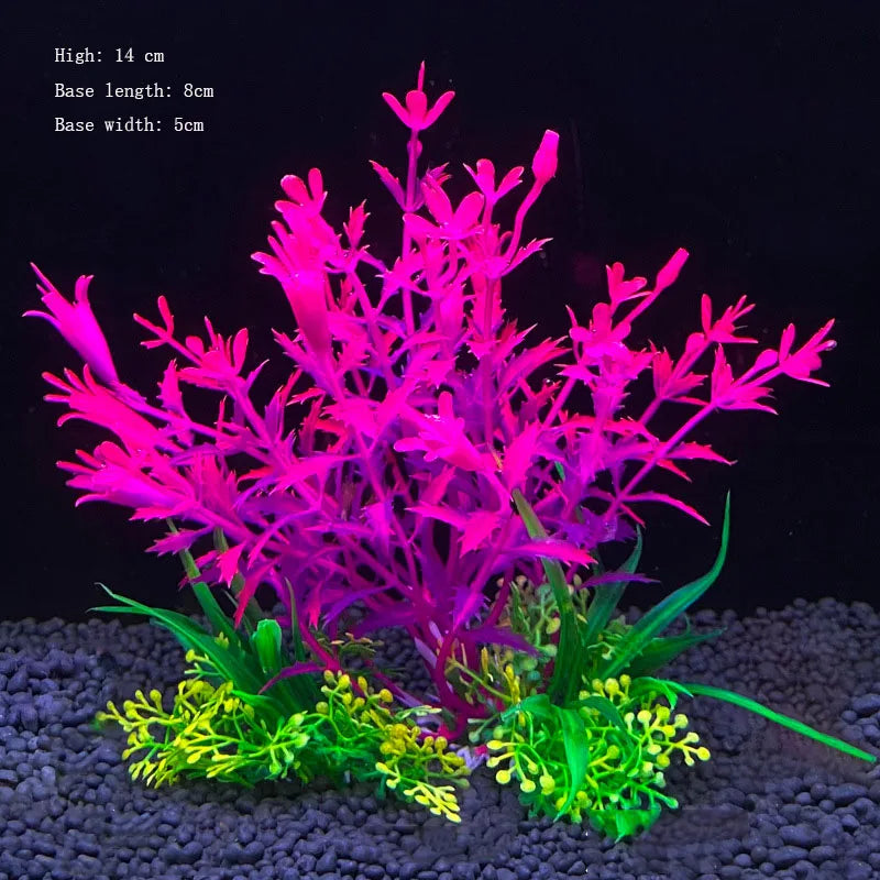 A vibrant artificial aquarium plant featuring bright pink and green foliage on a dark substrate.