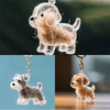 Clear resin dog figurine with light brown fur, designed as a keepsake pendant for a keychain.