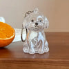 Clear glass keychain featuring a detailed dog silhouette, used for pet hair storage.