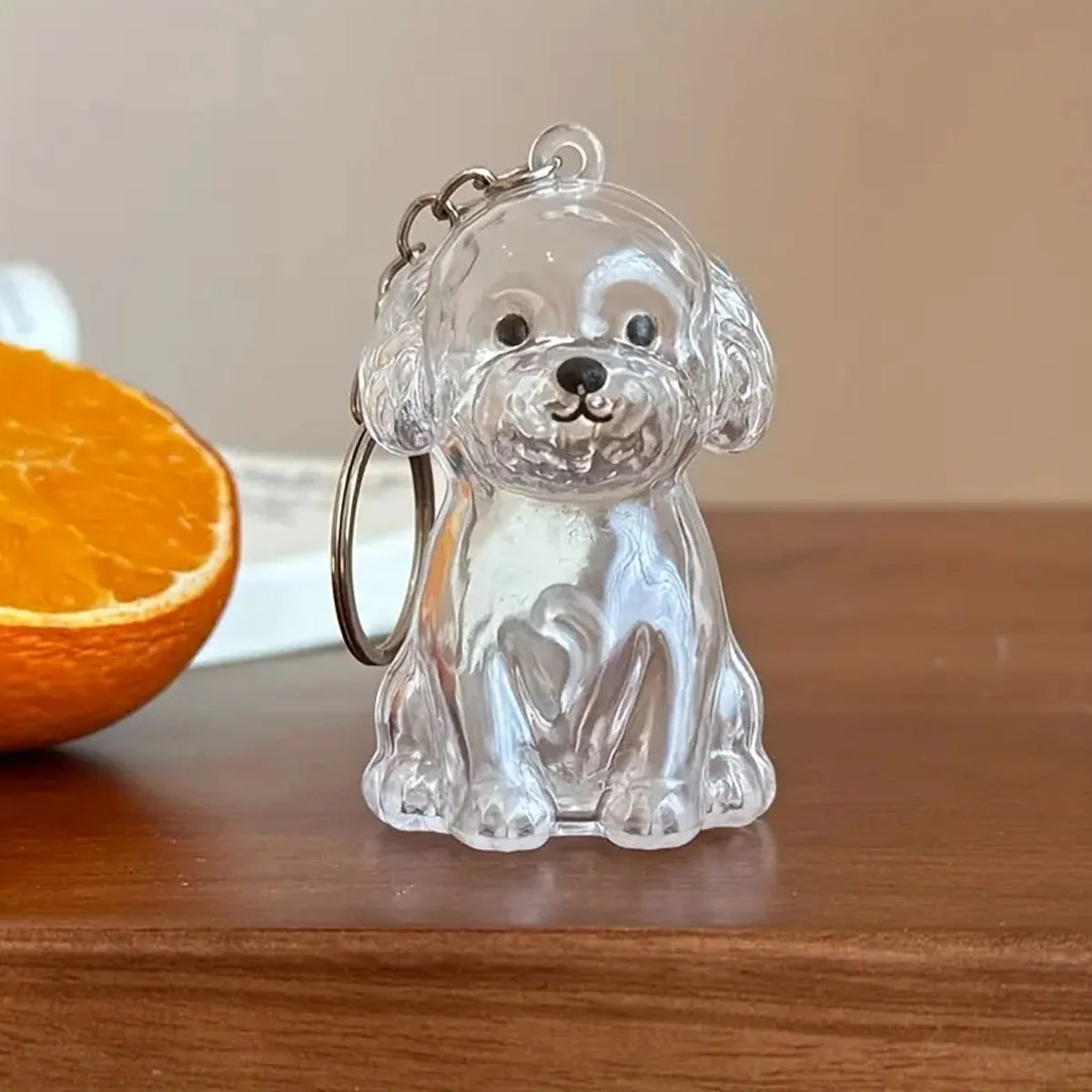 Clear glass keychain featuring a detailed dog silhouette, used for pet hair storage.