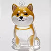 A clear acrylic keychain shaped like a fox dog with orange and white fur.