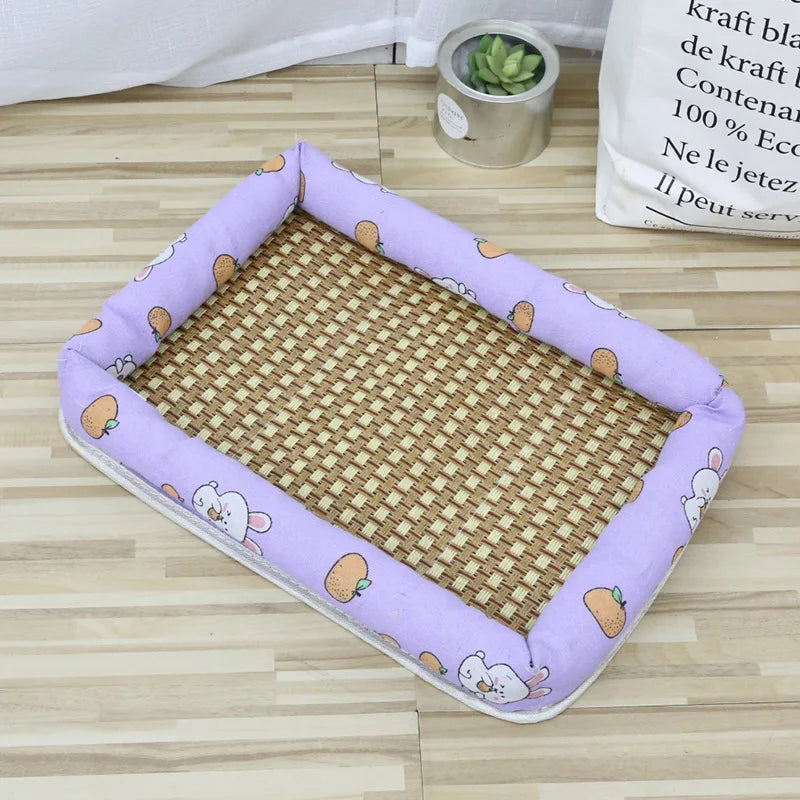 A purple pet bed with a woven mat featuring small fruit designs is shown on a wooden floor.