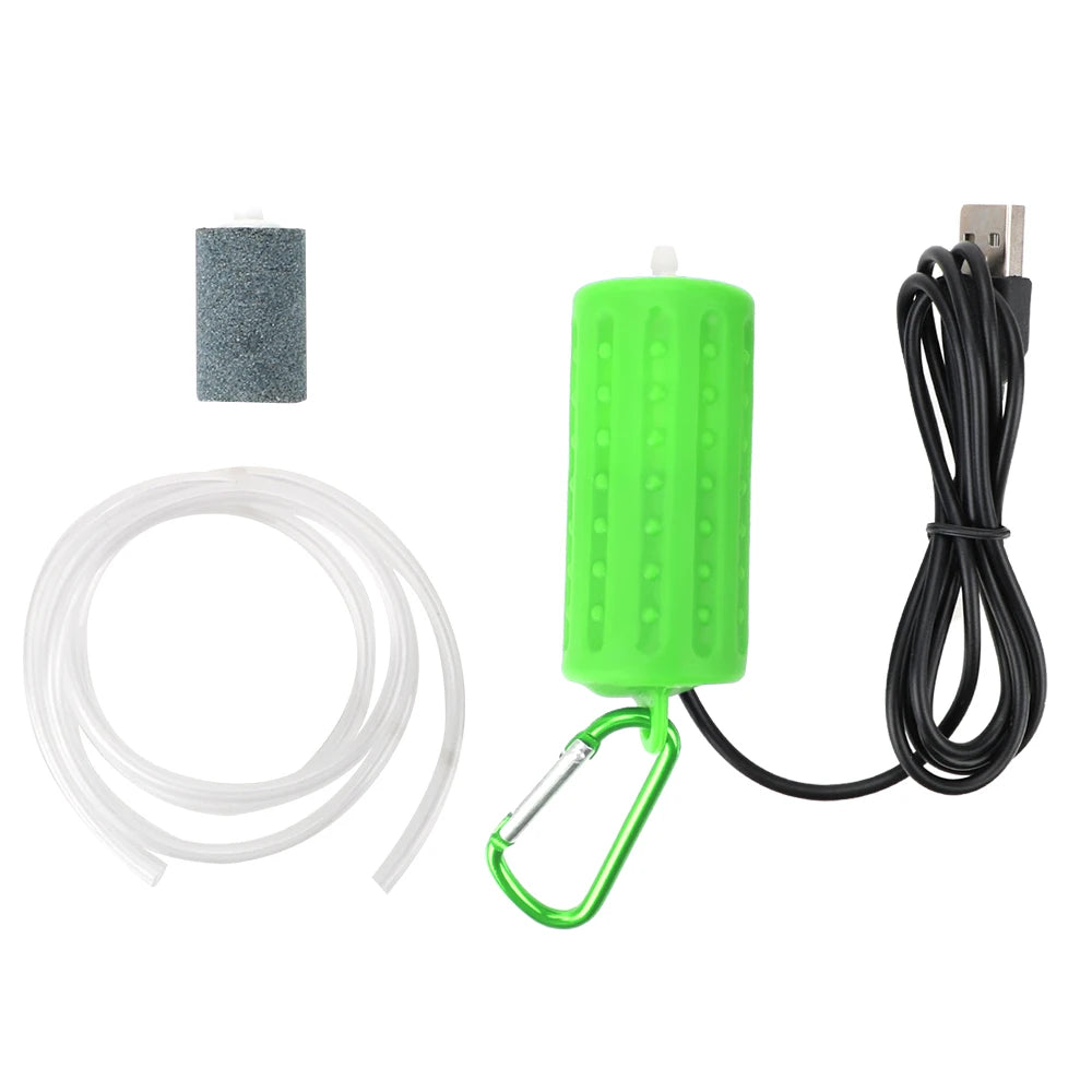 A portable USB aquarium air pump with a green plastic housing, a silicone tube, and an electrical cord.