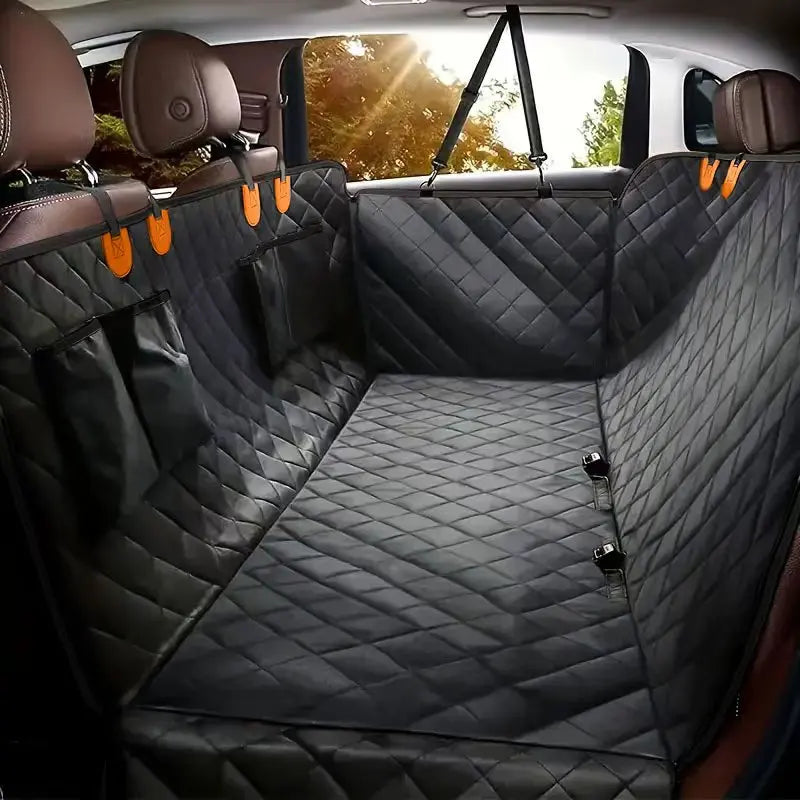 A dark gray quilted waterproof dog car seat cover hammock installed in the back seat of a vehicle.