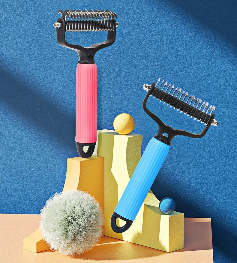 A pair of black and pink double-sided stainless steel dematting combs for dogs displayed on a yellow geometric stand.