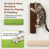 A tabby cat is climbing a vertical, dark brown fabric scratcher mounted on a wall.