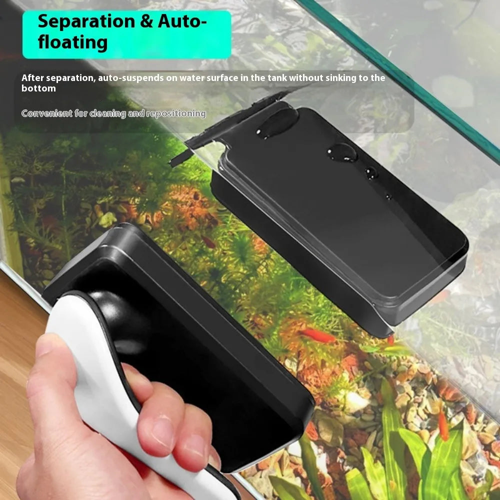 A hand is holding a black and white magnetic aquarium cleaning brush, demonstrating separation and auto-floating features.