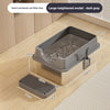 A large heightened dark gray semi-enclosed cat litter box with a stainless steel tray and grate shown on a wooden floor.