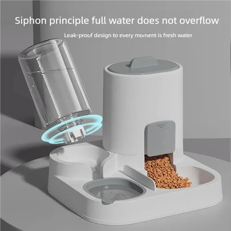 A white gravity cat feeder and water dispenser set with a clear glass and a food compartment.