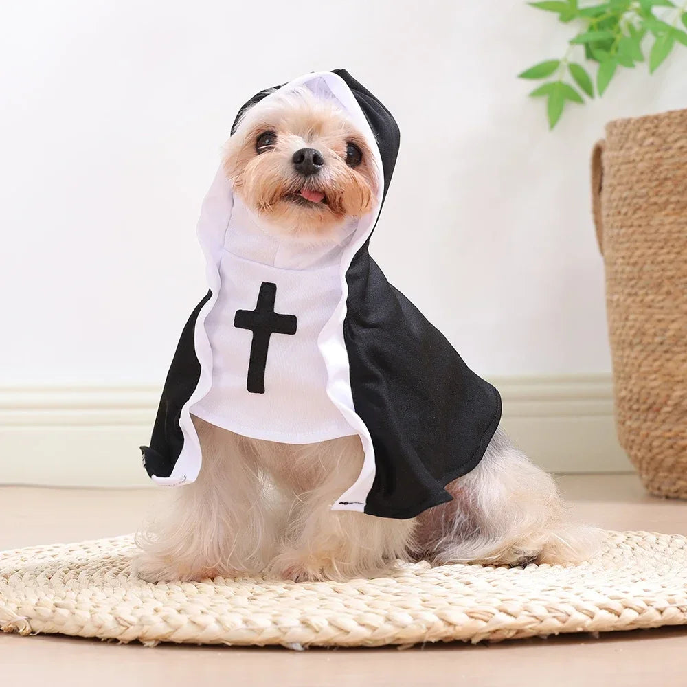 A small dog wearing a black and white nun costume with a cross on the front