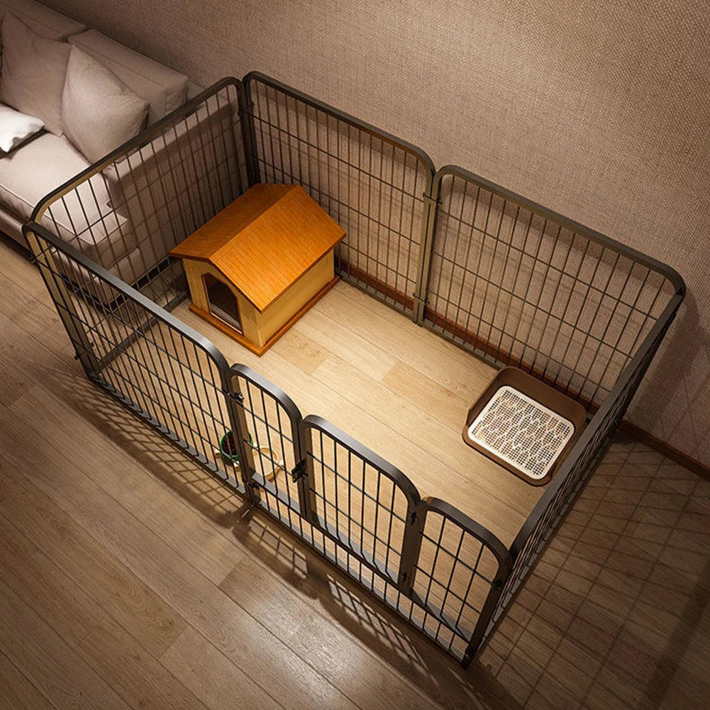 A wooden pet playpen with a mesh enclosure and a wooden feeder is shown on a light wood floor.