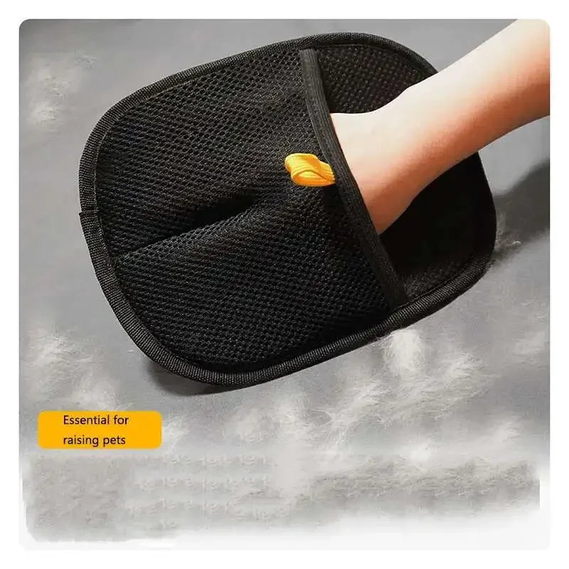 Black reusable pet grooming gloves being worn on a hand, intended for hair removal.
