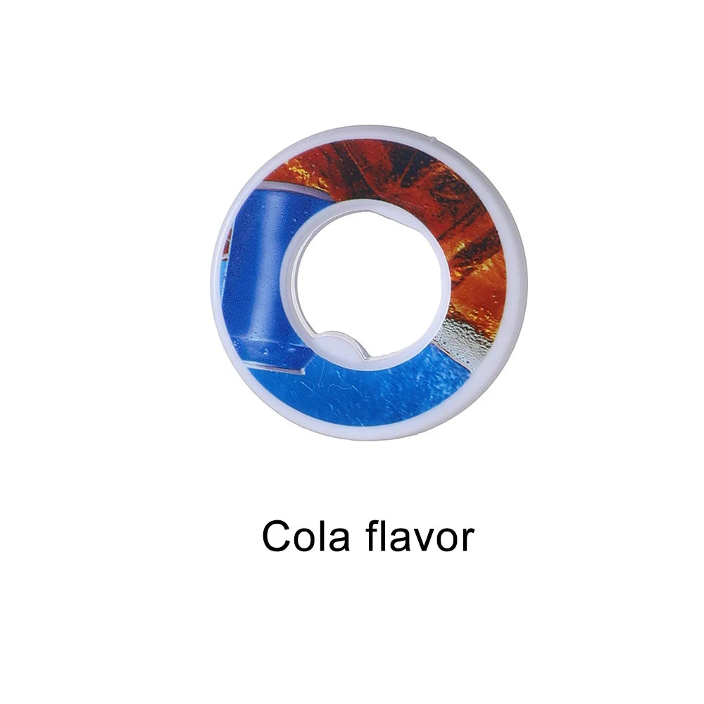 A circular flavor pod for water bottles with an orange and blue design, labeled Cola flavor.