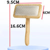 A wooden pet grooming brush with massage bristles is shown against a white background.