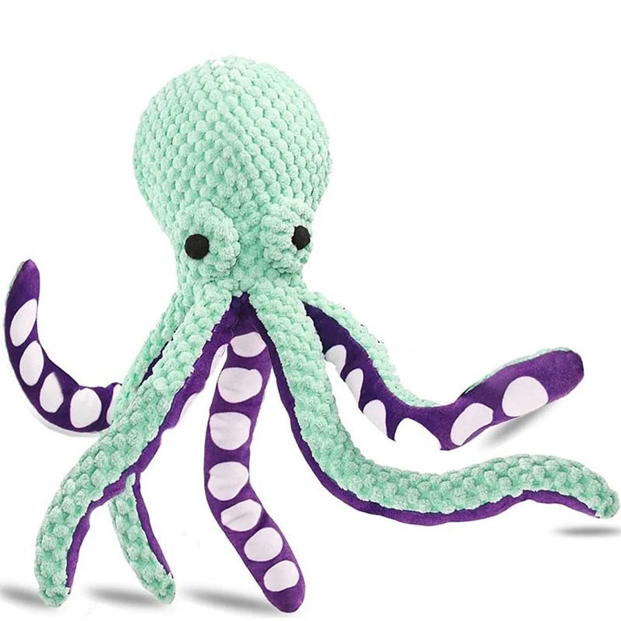 A soft green plush octopus toy with purple accents and polka dots.