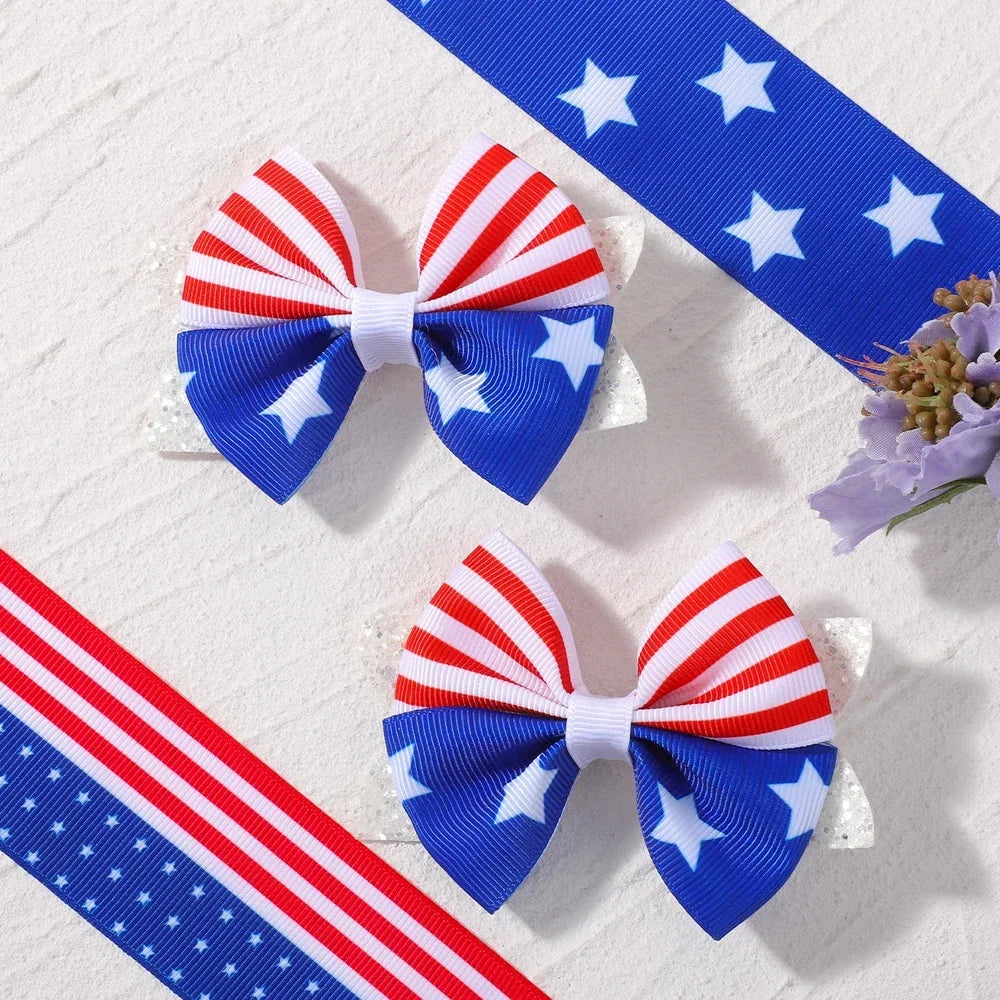 Two blue and white star ribbon hair bows with clips are displayed on a white background.