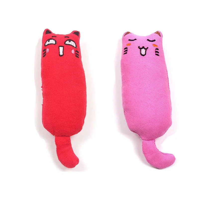 A red plush cat toy shaped like a face with pink accents and a pink plush cat toy.