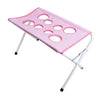 Hamac pliable rose pour toilettage d'animaux avec plusieurs poches en filet pour le bain et la coupe des griffes.
