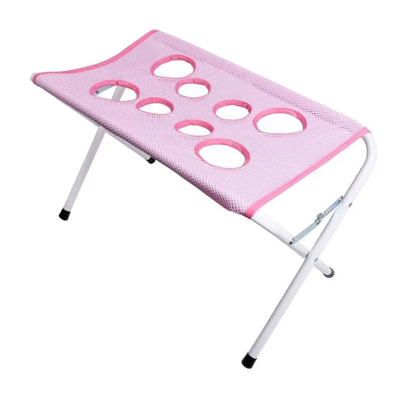 Hamac pliable rose pour toilettage d'animaux avec plusieurs poches en filet pour le bain et la coupe des griffes.