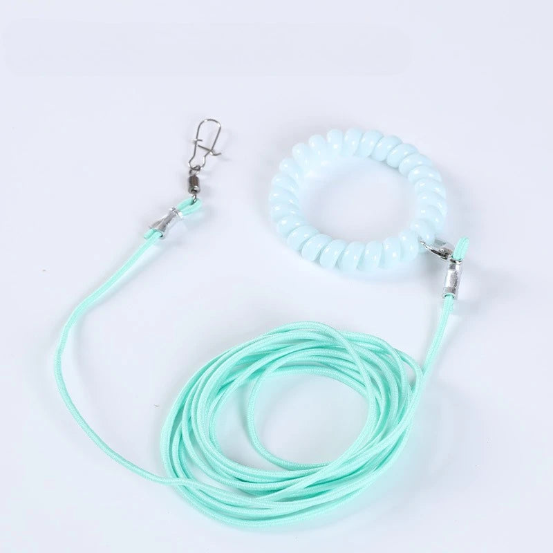 A light blue silicone outdoor training harness for parrots is shown coiled and with its attached leash.