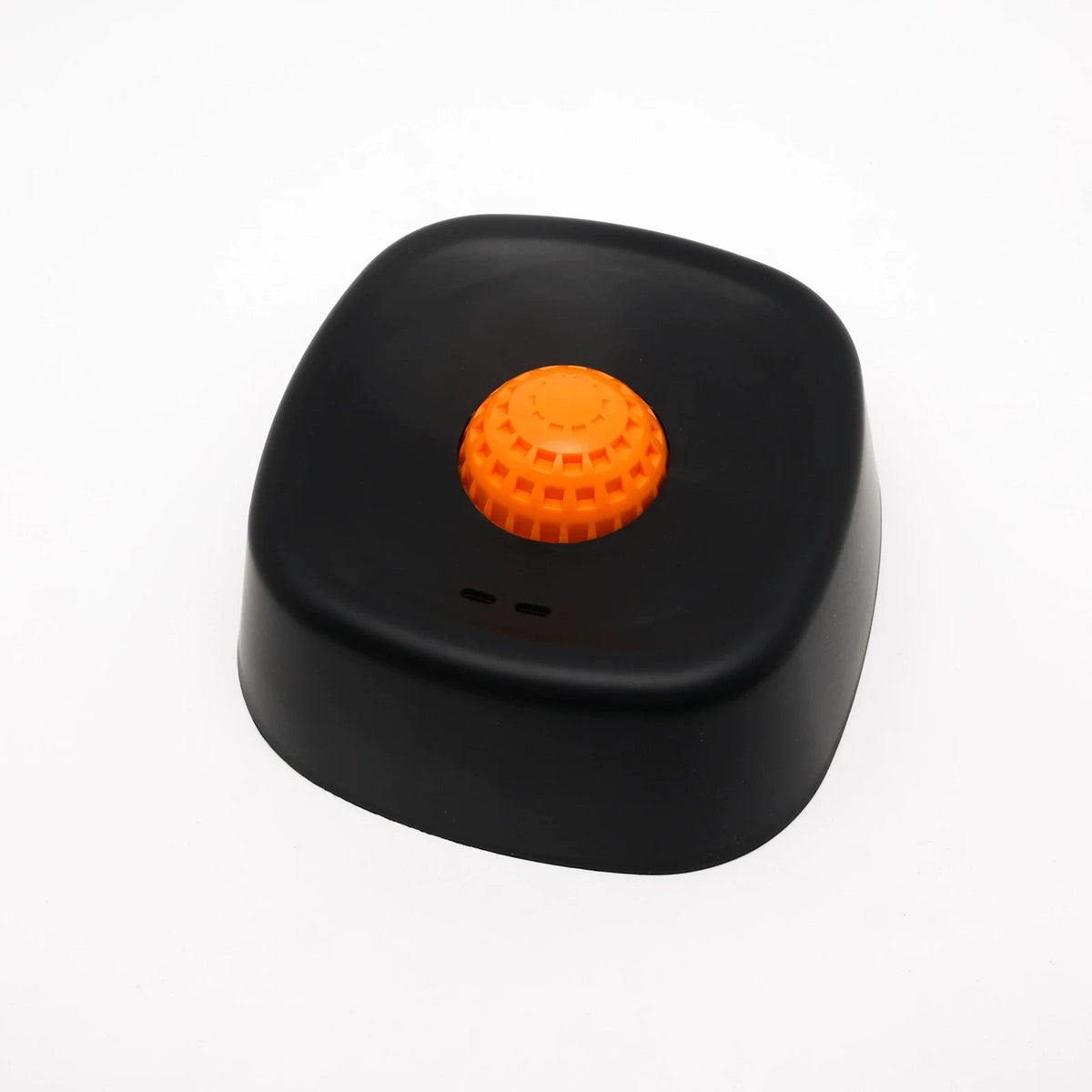 A black non-slip silicone lick mat slow feeder bowl for dogs and cats with an orange textured top.