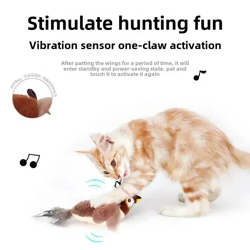 A fluffy orange tabby cat interacting with an electronic toy that simulates a bird with flapping wings.
