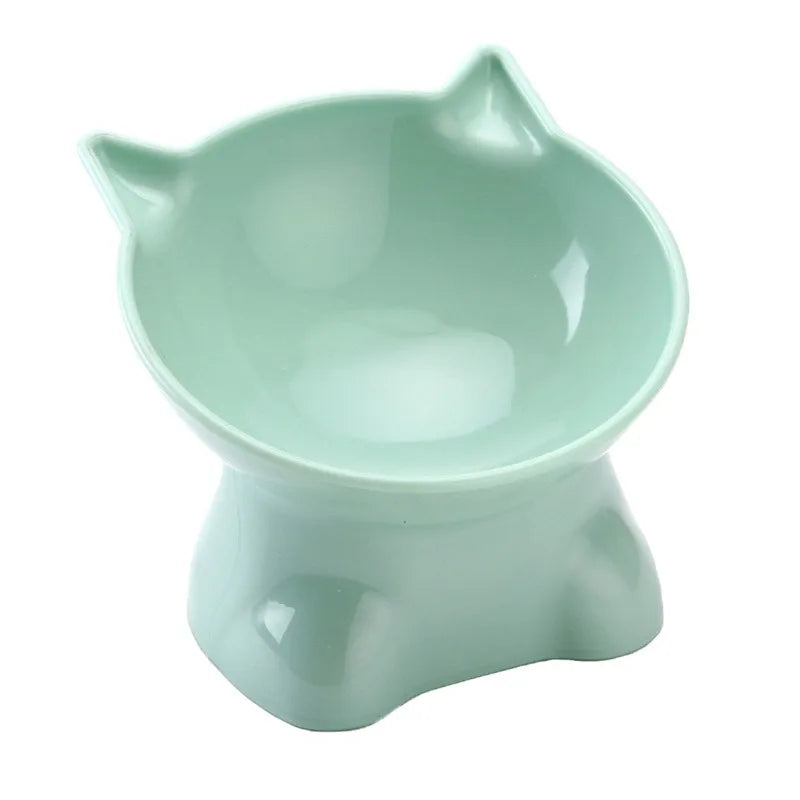 A light mint green ergonomic tilted cat feeding bowl with a slightly flared rim and a sturdy base.