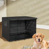 A black waterproof dog crate cover with mesh windows is placed on a wooden floor next to a golden retriever.