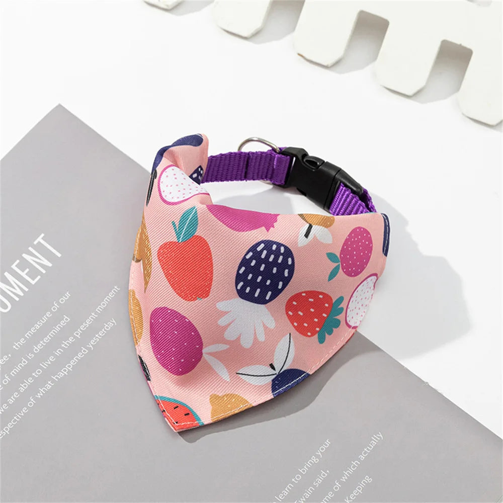 A pink bandana with a triangle collar band design featuring various fruit shapes for small dogs and cats.