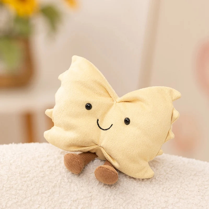 A light beige, soft plush toy shaped like a butterfly resting on a white surface.