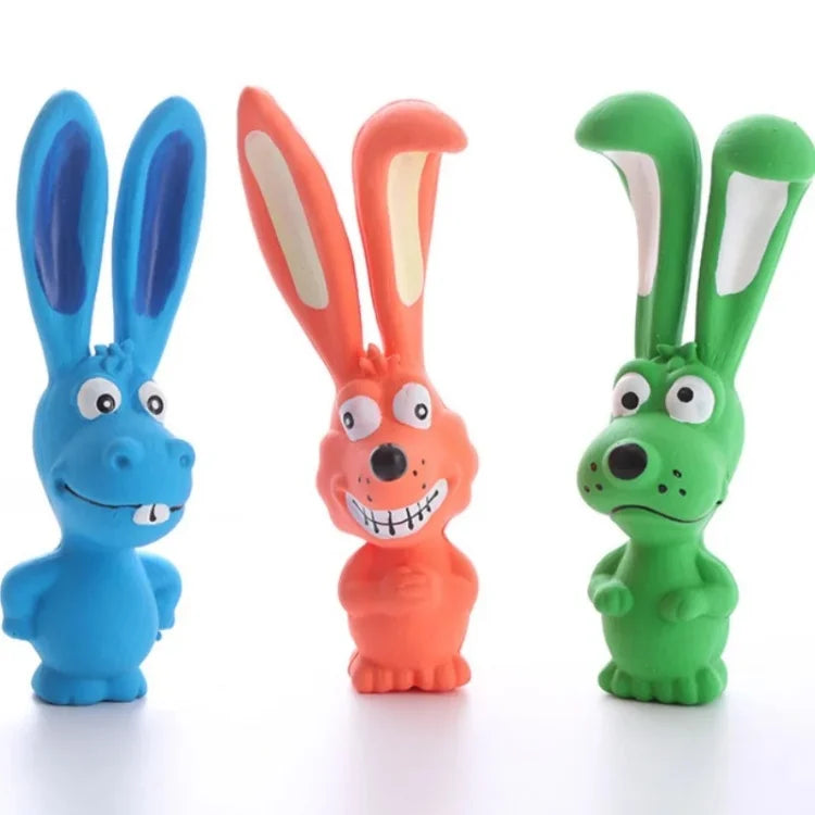 Three rubber squeaky rabbit chew toys in blue, orange, and green.