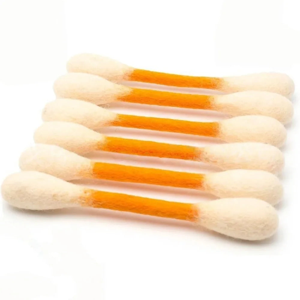 A set of oversized cotton swabs shaped like cat toys in white and orange.