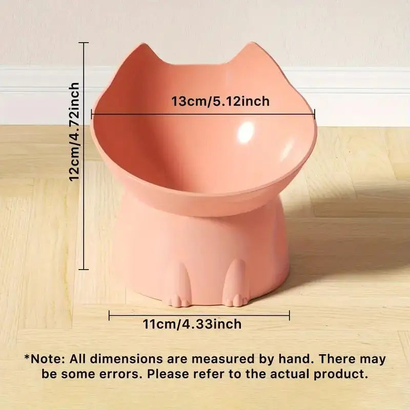 A pink elevated cat bowl with a storage feature and anti-tip base shown on a wooden surface.