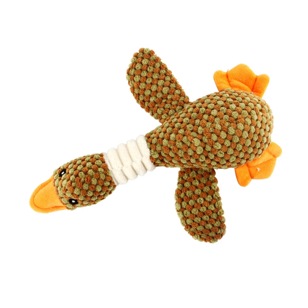 An animal-shaped squeaky dog toy covered in green corduroy fabric with orange accents.