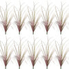 A collection of simulated onion grass garden decorations showing various shades of green and purple-pink foliage.