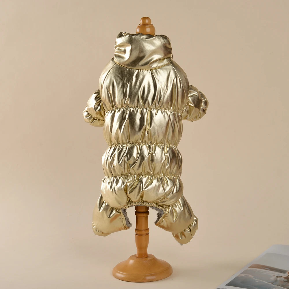 A gold metallic waterproof fleece-lined dog jumpsuit displayed on a wooden stand.