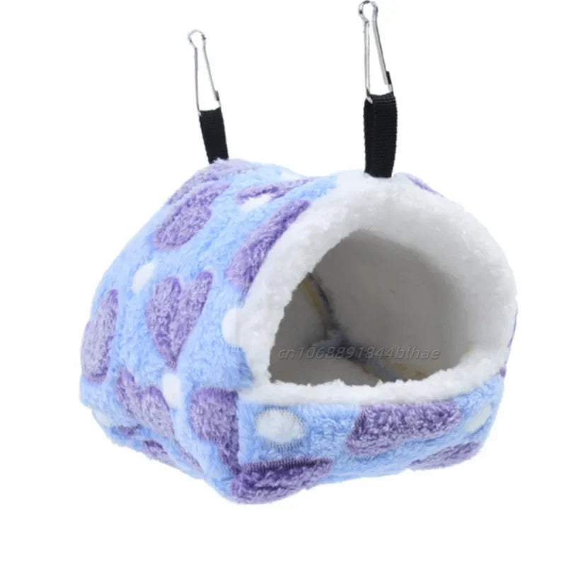 A fluffy purple and blue fleece pet nest bed with hanging loops.