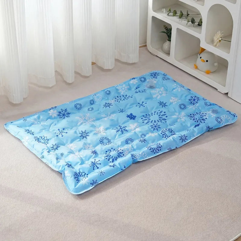 Light blue pet mat with a snowflake pattern placed on a light carpet in front of white curtains and shelving.