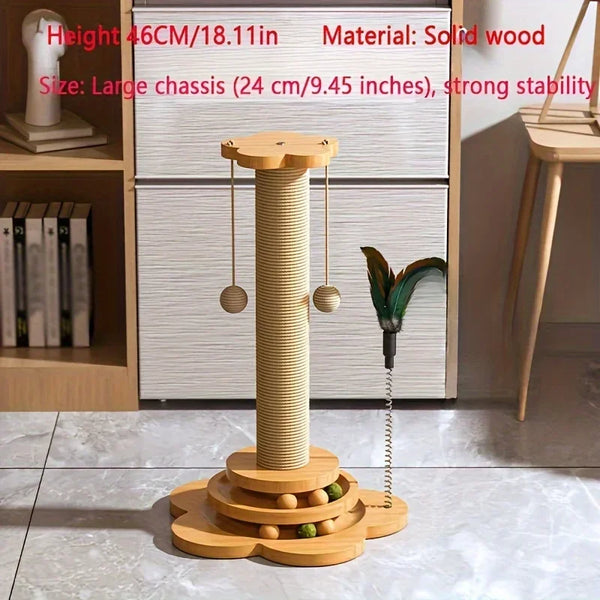 A solid wood cat scratcher turntable with a vertical post and a green teaser wand sits on a light-colored surface.