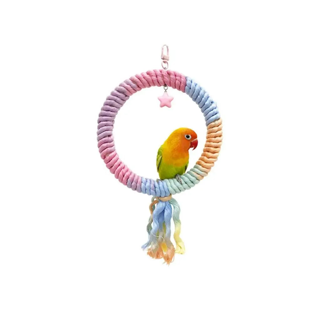 A bendable cotton rope perch for small birds, featuring a purple and white braided ring with a pink charm.
