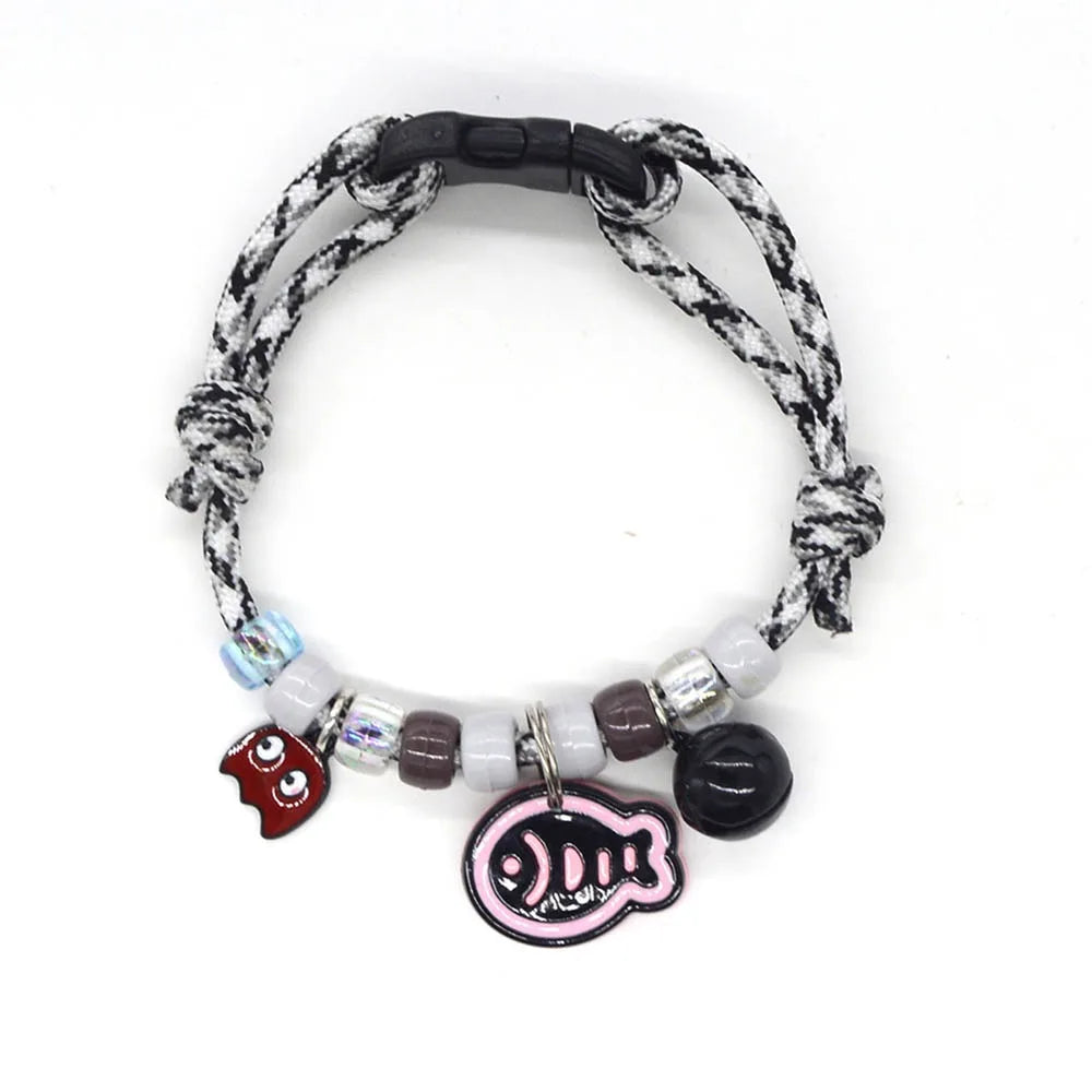 A colorful braided pet collar with a bell for cats and small dogs featuring white, gray, and dark accents.