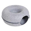 A round, gray felt cat bed with a tunnel entrance and a zippered opening.