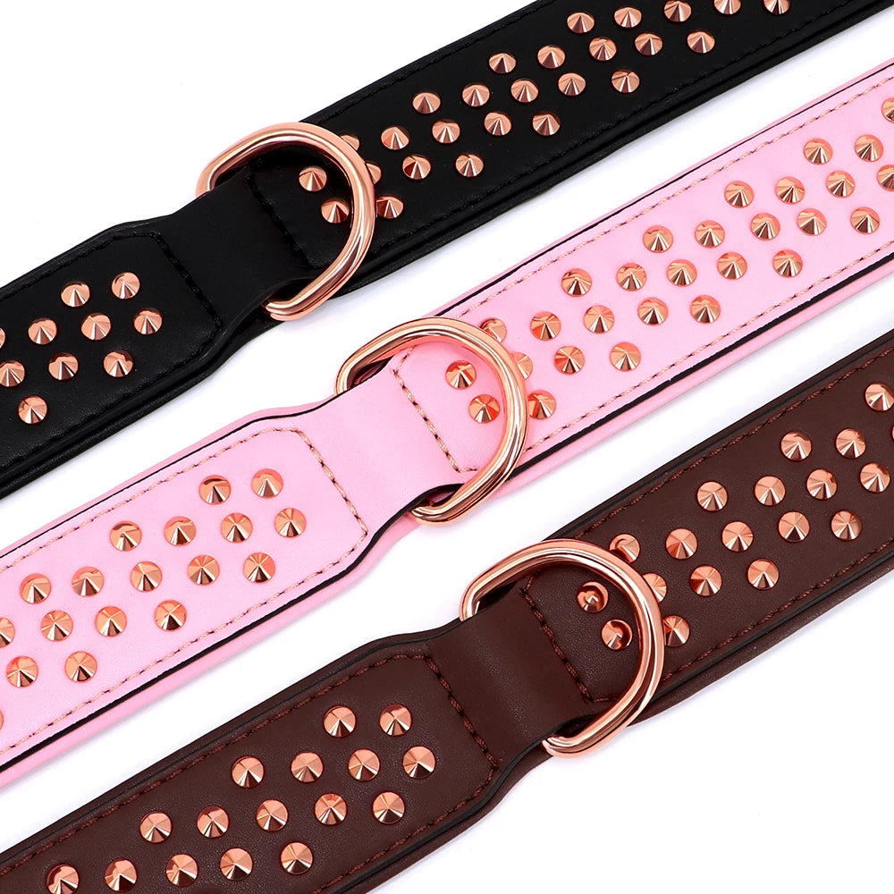 A close-up view of an adjustable leather dog collar with metal spikes in black, pink, and brown colors.