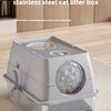 A fully enclosed stainless steel cat litter box with a flip-top lid shown on a wooden surface.