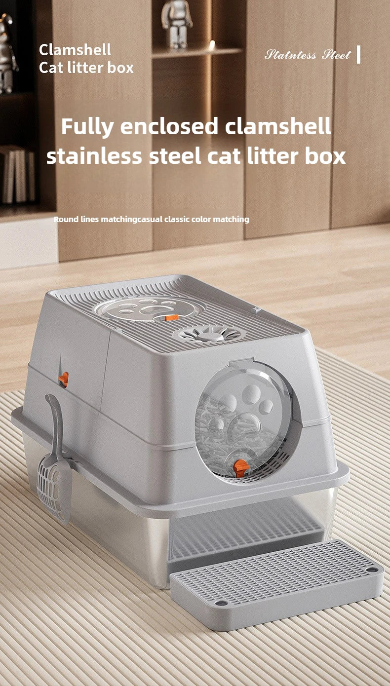 A fully enclosed stainless steel cat litter box with a flip-top lid shown on a wooden surface.