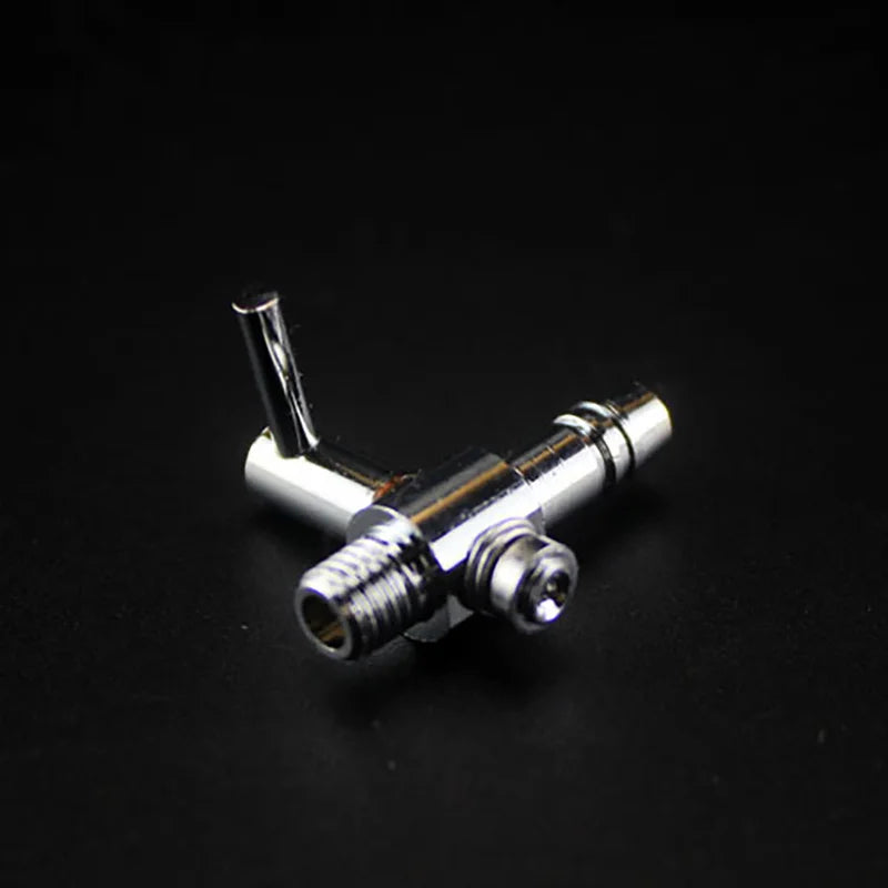 A close-up view of a stainless steel aquarium air splitter valve with a threaded connection and an angled tube.