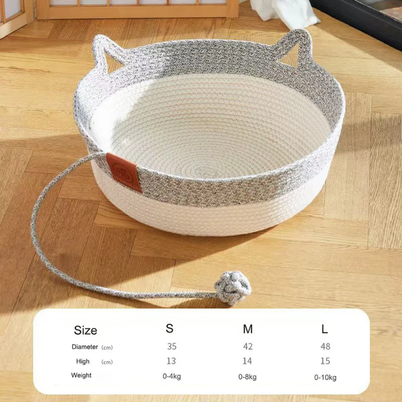 Handwoven rattan cat bed with a cotton rope edge shown on a wooden floor.