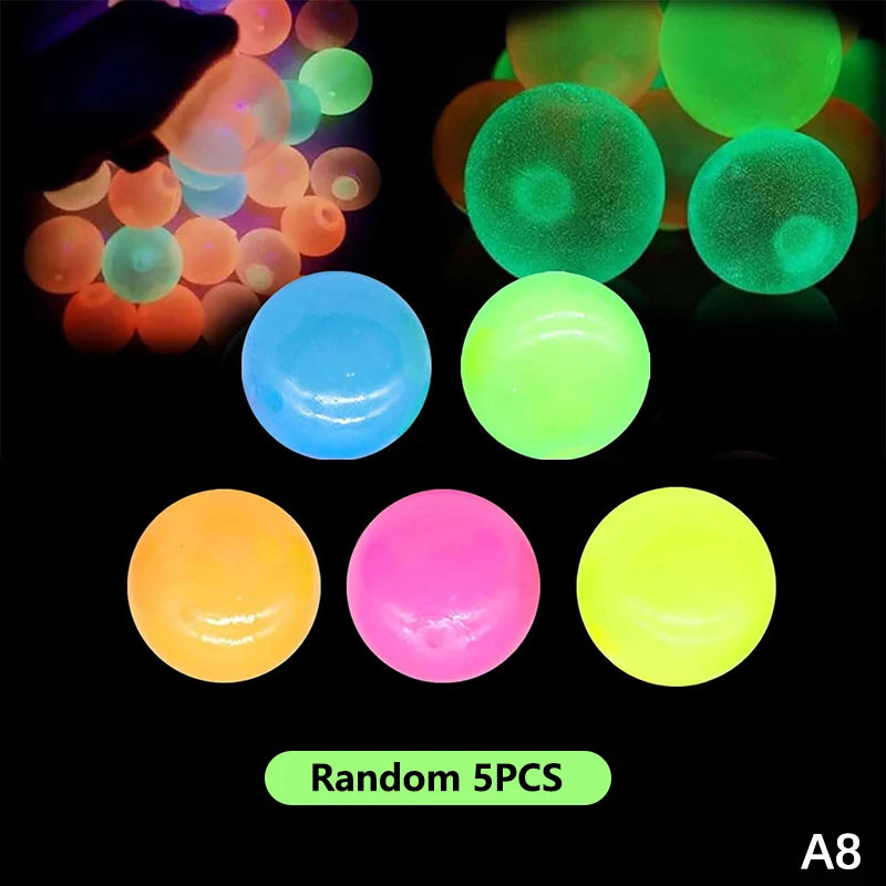 A collection of five glow-in-the-dark sticky sensory balls in various colors including blue, green, orange, pink, and yellow.