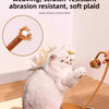 A fluffy white cat is playing with a handmade cotton rope toy on a woven mat.
